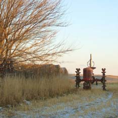 tractor moving along a barren field