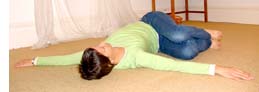 woman doing twist stretch on floor
