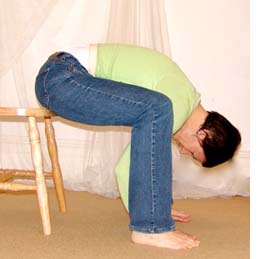 woman doing forward bend in chair
