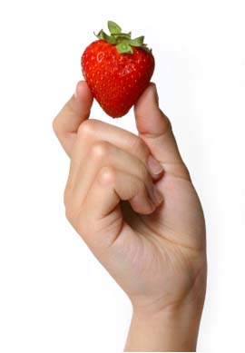 hand holding a single strawberry