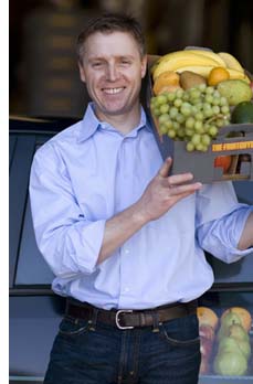 Chris Mittelstaedt holding a box of fruit