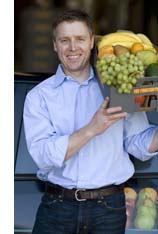 Chris Mittelstaedt holding a box of fruit