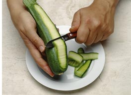 person peeling zucchini