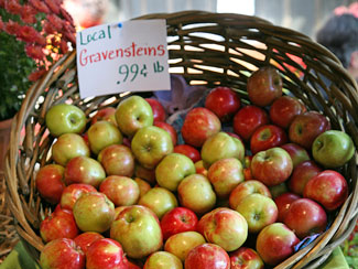 basket of apples with a note that reads, "Local Gravensteins .99 cents per pound"