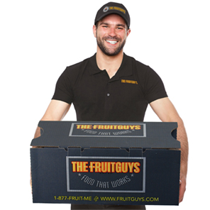 A man with holding a large box of FruitGuys fruit