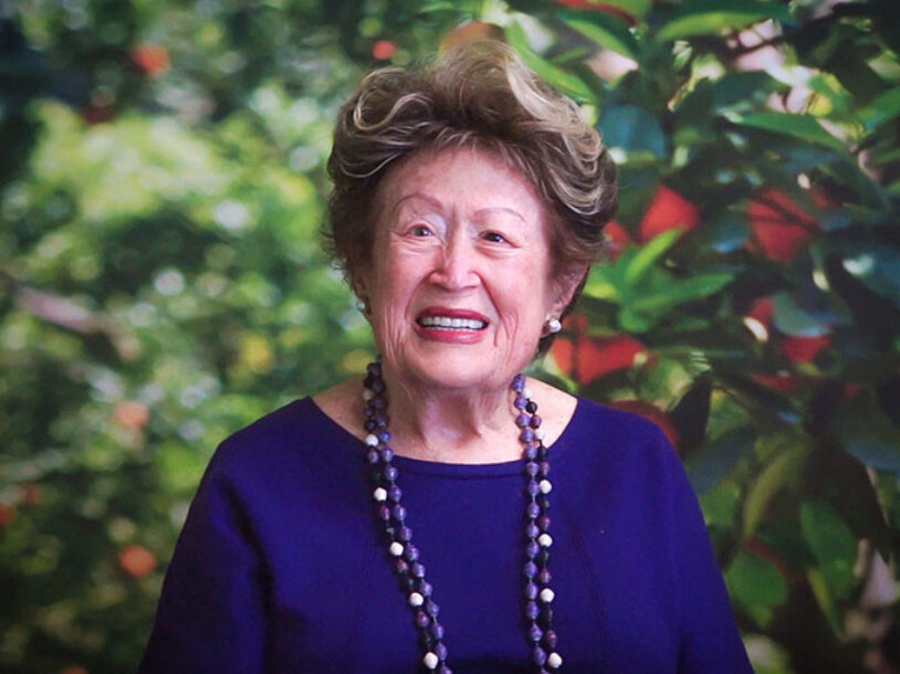 Smiling older woman in an orchard