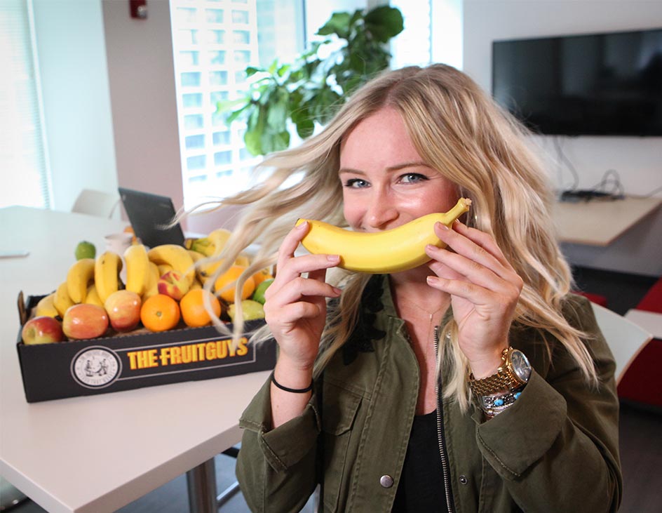 woman with banana smiling
