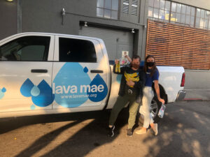 Staff at Lava Mae in Oakland, CA show off freshly donated bananas 