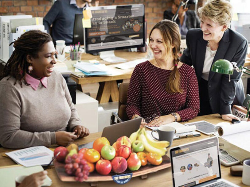 group in office with fruit