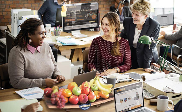 group in office with fruit