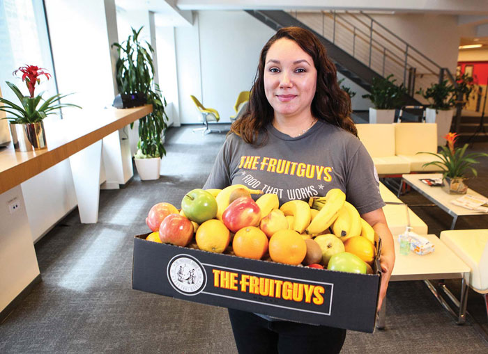 woman carrying Fruitguys box
