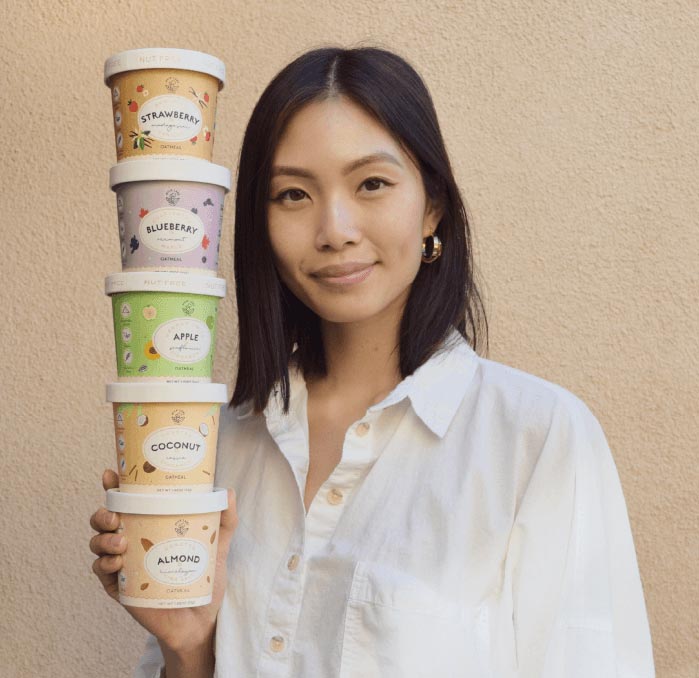 Woman holding stack of oatmeal cups