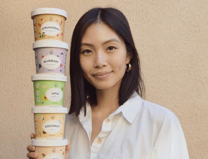 Woman holding stack of oatmeal cups