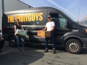 The FruitGuys team members in front of a FruitGuys van