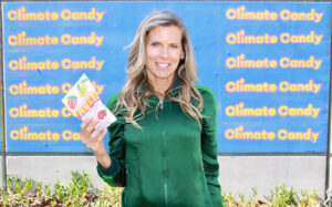 Climate Candy Co-founder Amy Keller holding FAVES with Climate Candy written in the background