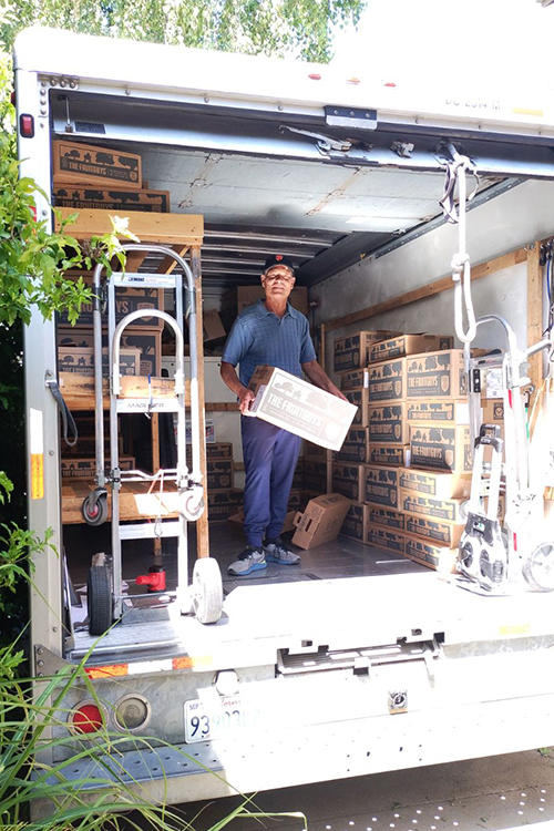 Driver in a truck full of The FruitGuys boxes