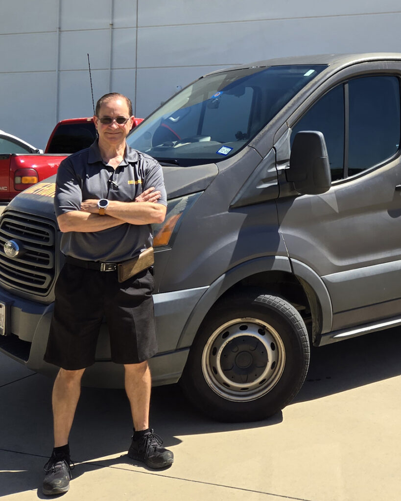 Fresh fruit delivery driver standing in front of van