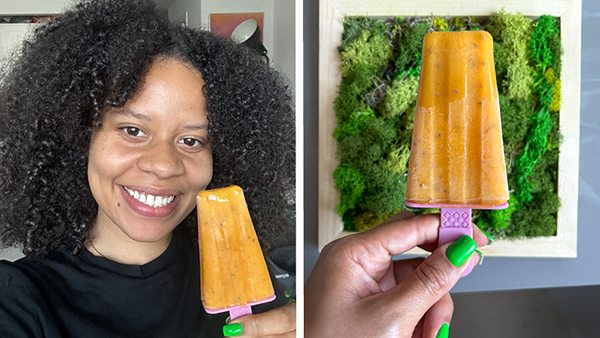 Steffy holding a mango-orange popsicle, popsicle against green background