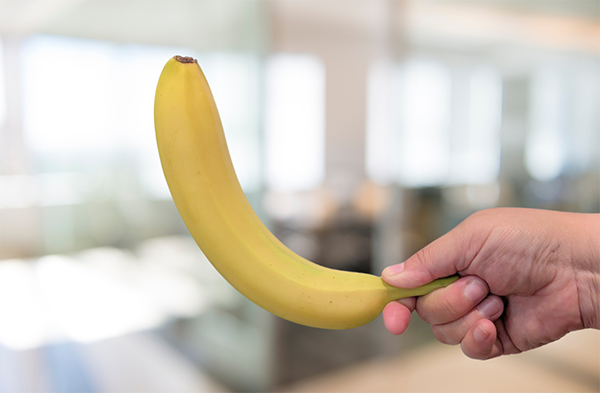 Person holding banana in correct snap position