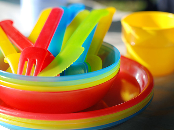 Plastic plates, bowls, knives, spoons, and forks