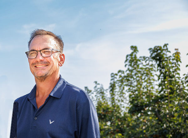 Man smiling in orchard