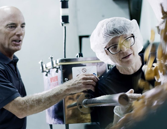 Man and woman working on production line