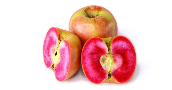 Apples with red-pink insides, one whole one cut