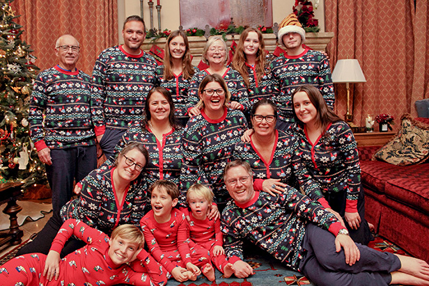 Smiling family in matching Christmas pajamas