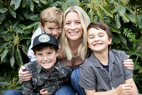 Smiling woman and three boys