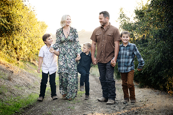 Smiling parents and three sons