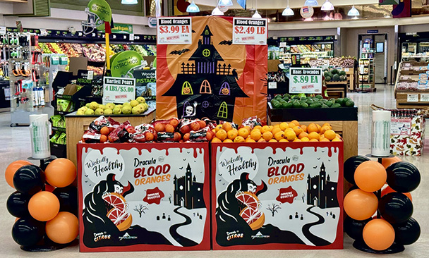 Dracula Blood Orange store display with Wickedly Healthy slogan and vampire mascot