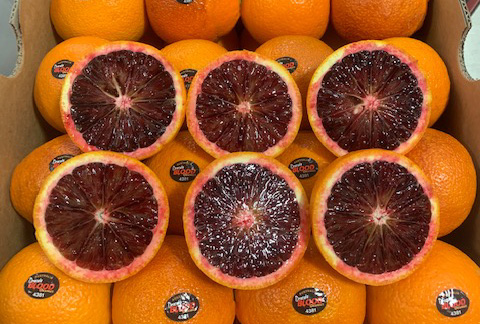 Halved and whole Dracula™ blood oranges