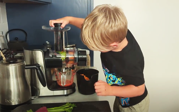 Boy making fresh-squeezed juice