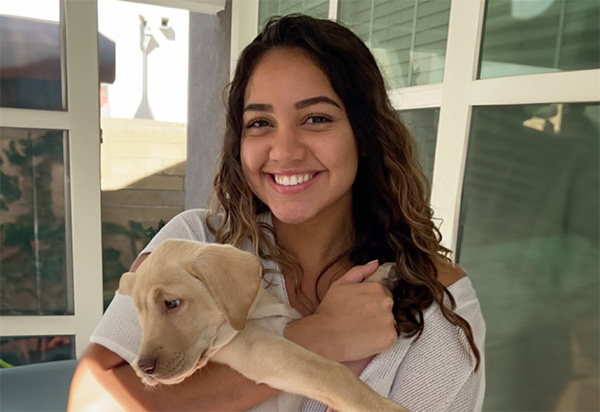 Smiling woman holding puppy