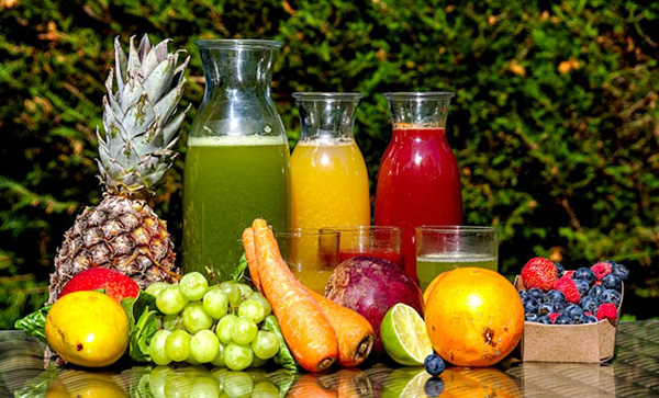 Fresh-squeezed juice outdoors with colorful produce