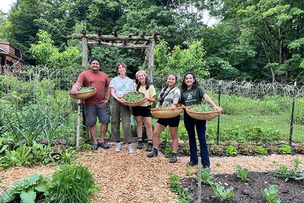 Smiling farmers holding their harvest