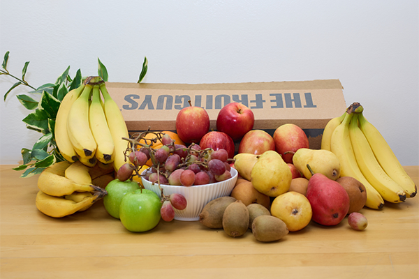 The FruitGuys box surrounded by fresh fruit