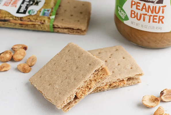 Peanut Butter Graham Sandwiches in front of more snacks and peanut butter