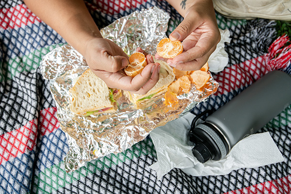 Kid eating lunch on a blanket