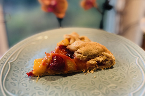 Slice of galette made with seasonal summer fruit