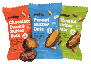 Realsy Chocolate Peanut Butter Date, Peanut Butter Date, and Almond Butter Date in packaging, one date out of packaging