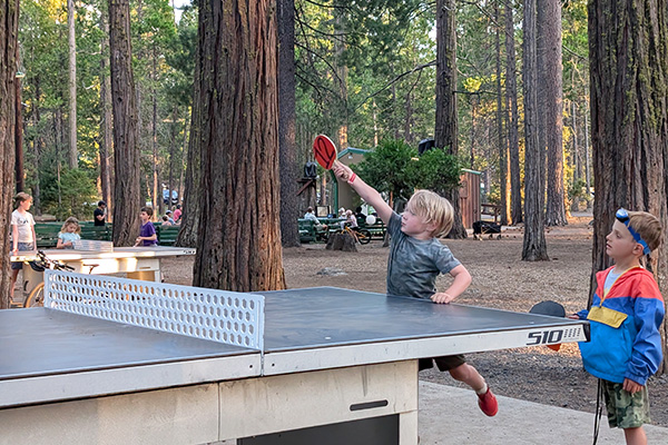 Kids playing ping-pong at camp