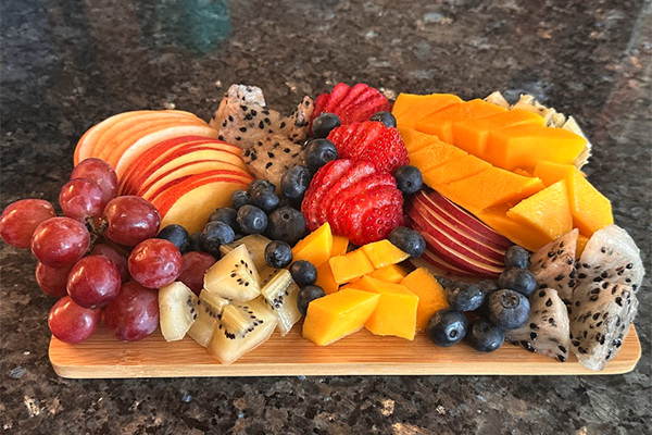 Charcuterie board with a variety of colorful fruit