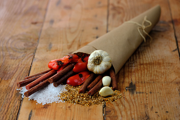 Paper cone spilling out pepperoni meat sticks and fresh ingredients