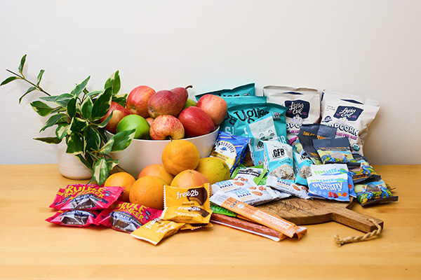 Pile of fruit and packaged snacks
