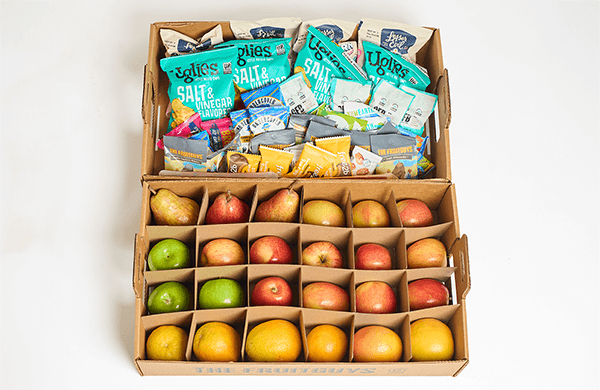 The FruitGuys Fruit & Snacks Gift, showing one tray of fresh fruit and one tray of single-serving packaged snacks