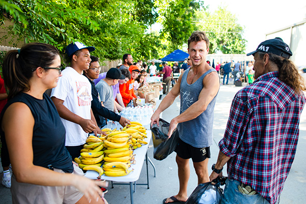 Man in line to collect free bananas, water, and other supplies