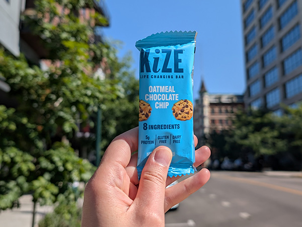 KiZE Bar held up against a cityscape