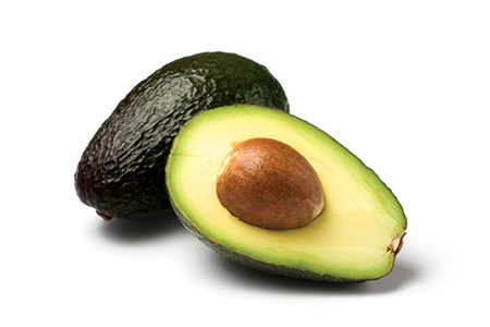 Whole and halved avocado
