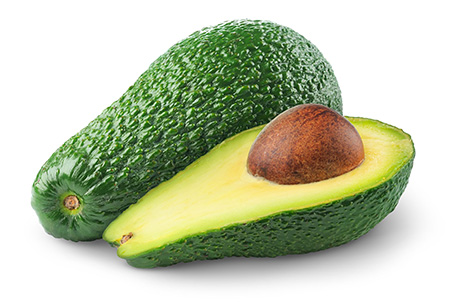 Whole and halved avocado